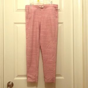 Pink sweatpants with pockets and drawstring.